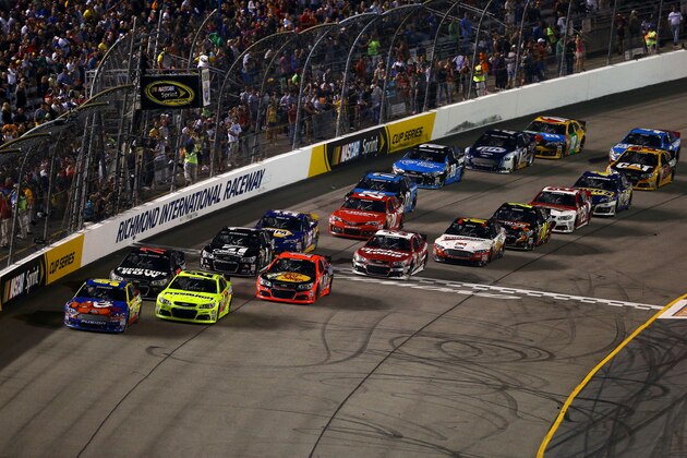 RICHMOND, VA - SEPTEMBER 07:  Carl Edwards, driver of the #99 Kellogg's / Cheez-It Ford, leads the field to a restart during the NASCAR Sprint Cup Series 56th Annual Federated Auto Parts 400 at Richmond International Raceway on September 7, 2013 in Richmond, Virginia.  (Photo by Streeter Lecka/Getty Images)