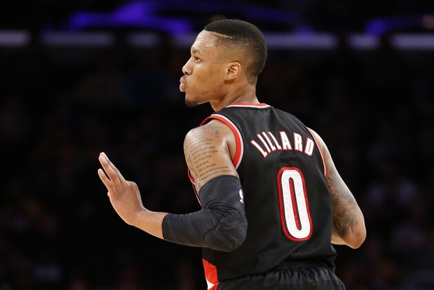 Portland Trail Blazers guard Damian Lillard reacts after making a three-pointer against the Los Angeles Lakers during the second half of an NBA basketball game in Los Angeles, Tuesday, April 1, 2014. The Trail Blazers won 124-112. (AP Photo/Danny Moloshok)