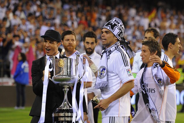 VALENCIA, SPAIN - APRIL 16:  (From L-R) Cristiano Ronaldo, Pepe and Fabio Coentrao hold the Copa del Rey trophy after beating Barcelona 2-1 in the final at Estadio Mestalla on April 16, 2014 in Valencia, Spain.  (Photo by Denis Doyle/Getty Images)