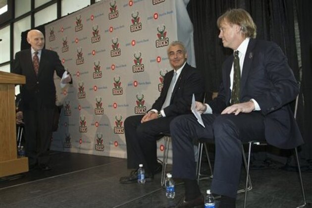 CORRECTS TO LASRY AT CENTER, INSTEAD OF AT RIGHT - Milwaukee Bucks owner Herb Kohl introduces investment firm executives Marc Lasry, center, and Wesley Edens right, at a news conference after reaching a deal to sell the franchise Wednesday, April 16, 2014, in Milwaukee. The deal is subject to approval by the NBA and its Board of Governors. (AP Photo/Morry Gash)
