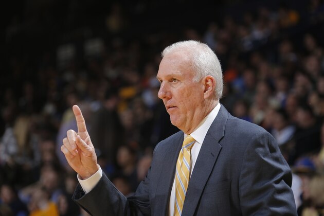 San Antonio Spurs coach Gregg Popovich, center, talks to his assistants during the second half of an NBA basketball game against the Los Angeles Lakers, Wednesday, April 16, 2014, in San Antonio. Los Angeles won 113-100. (AP Photo/Eric Gay)