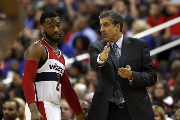 Washington Wizards guard John Wall listens to head coach Randy Wittman in the second half of an NBA basketball game against the Miami Heat, Monday, April 14, 2014, in Washington. The Wizards won 114-93. (AP Photo/Alex Brandon)