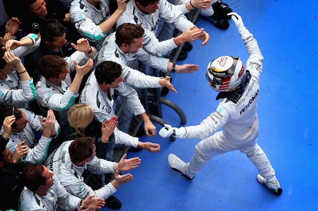 SHANGHAI, CHINA - APRIL 20:  Lewis Hamilton of Great Britain and Mercedes GP celebrates his victory with his team following the Chinese Formula One Grand Prix at the Shanghai International Circuit on April 20, 2014 in Shanghai, China.  (Photo by Clive Mason/Getty Images)