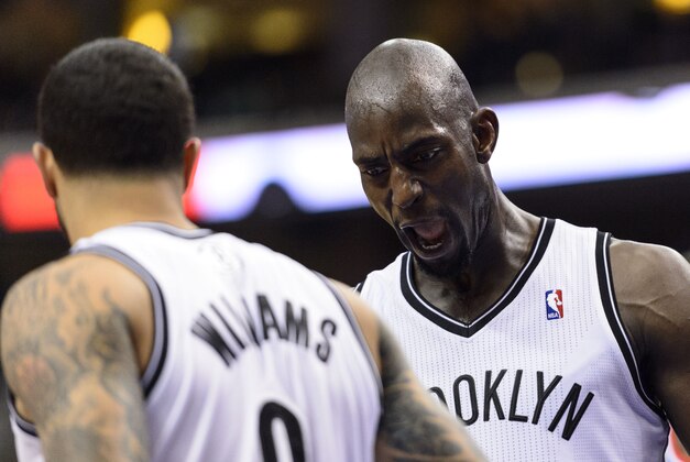 Apr 5, 2014; Philadelphia, PA, USA; Brooklyn Nets center Kevin Garnett (2) celebrates with guard Deron Williams (8) during the third quarter against the Philadelphia 76ers at the Wells Fargo Center. The Nets defeated the Sixers 105-101. Mandatory Credit: Howard Smith-USA TODAY Sports