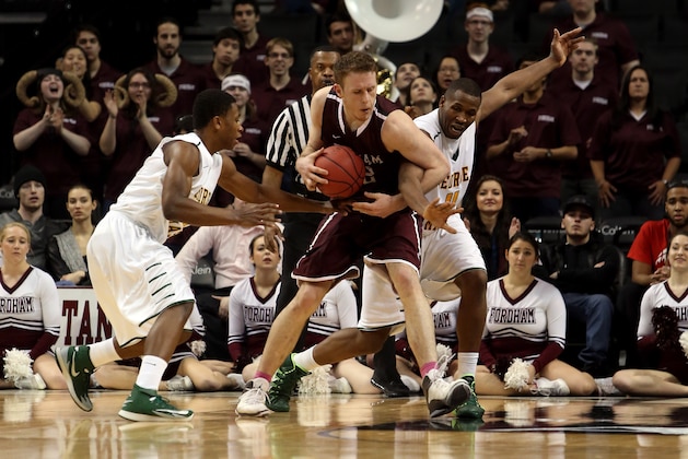 NEW YORK, NY - MARCH 12: Ryan Canty #42 of the Fordham Rams handles the ball against Marquise Moore #22 and Erik Copes #4 of the George Mason Patriots in the second half during the first round of the Atlantic 10 Men's Basketball Tournament at Barclays Center on March 12, 2014 in the Brooklyn Borough of New York City.  (Photo by Mike Lawrie/Getty Images)
