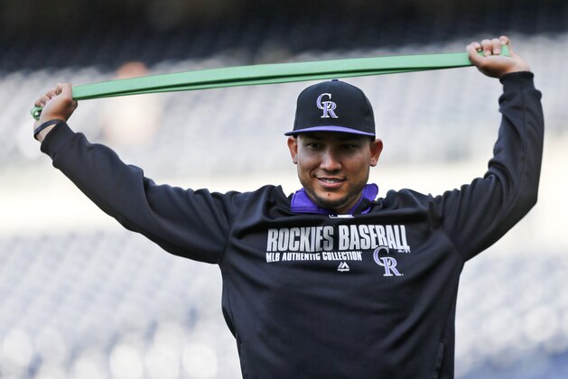 Colorado Rockies left fielder Carlos Gonzalez uses a stretching band to get ready during pre game activities at MLB National League baseball game against the San Diego Padres Tuesday, April 15, 2014, in San Diego. (AP Photo/Lenny Ignelzi) Colorado Rockies left fielder Carlos Gonzalez uses a stretching band to get ready during pre game activities at MLB National League baseball game against the San Diego Padres Tuesday, April 15, 2014, in San Diego. (AP Photo/Lenny Ignelzi)
