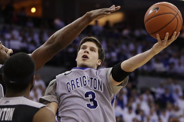 FILE - In this March 8, 2014 file photo, Creighton's Doug McDermott (3) goes for a layup against Providence's LaDontae Henton (23) and Providence's Kadeem Batts (10) in an NCAA college basketball game in Omaha, Neb. McDermott  was selected to The Associated Press All-America team, released Monday, March 31, 2014. (AP Photo/Nati Harnik)