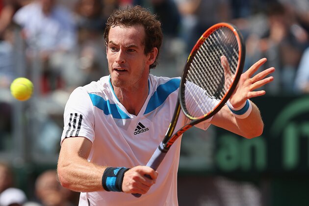 NAPLES, ITALY - APRIL 06:  Andy Murray of Great Britain plays a backhand volley during his straight sets defeat in the fourth rubber by Fabio Fognini of Italy  during day three of the Davis Cup World Group Quarter Final match between Italy and Great Britain at Tennis Club Napoli  on April 6, 2014 in Naples, Italy.  (Photo by Clive Brunskill/Getty Images)