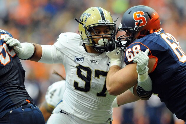 Nov 23, 2013; Syracuse, NY, USA; Pittsburgh Panthers defensive lineman Aaron Donald (97) is blocked by Syracuse Orange guard Nick Robinson (68) during the second quarter at the Carrier Dome.  Mandatory Credit: Rich Barnes-USA TODAY Sports