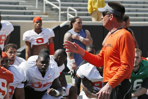 Oklahoma State head coach Mike Gundy talks to his team following an Orange Blitz spring practice open to the public in Stillwater, Okla., Saturday, April 5, 2014. (AP Photo/Sue Ogrocki)