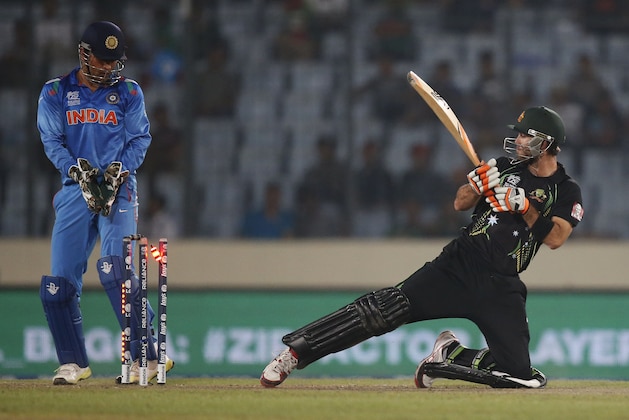 Australia's batsman Glenn Maxwell, right, is bowled out by India's bowler Ravichandran Ashwin during their ICC Twenty20 Cricket World Cup match in Dhaka, Bangladesh, Sunday, March 30, 2014. (AP Photo/Aijaz Rahi)