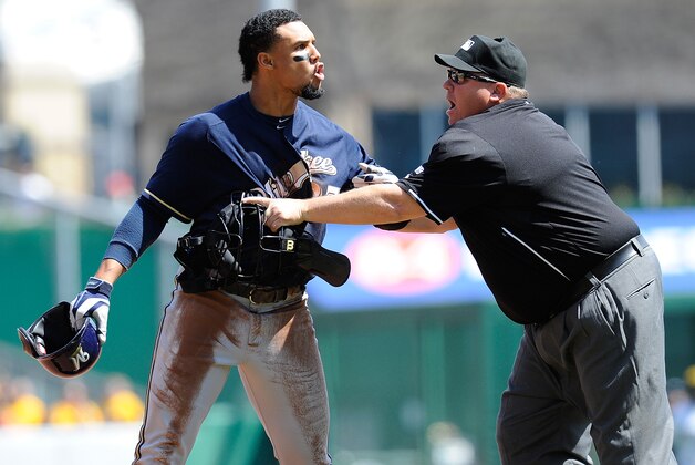 Milwaukee Brewers' Carlos Gomez (27) tries to get past umpire Fieldin Culbreth, center, Pittsburgh Pirates third  baseman Josh Harrison (5) to get to Pittsburgh Pirates starting pitcher Gerrit Cole during the third inning of a baseball game in Pittsburgh Sunday, April 20, 2014. A dugouts clearing brawl ensued, with Gomez at the center, causing him to be ejected from the game. (AP Photo/Gene J. Puskar)