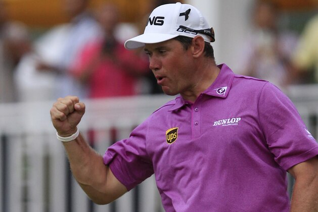 Lee Westwood of England celebrates after winning the Malaysian Open golf tournament at Kuala Lumpur Golf and Country Club in Kuala Lumpur, Malaysia, Sunday, April 20, 2014. (AP Photo/Lai Seng Sin)