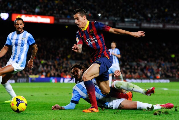 BARCELONA, SPAIN - JANUARY 26:  Cristian Tello of FC Barcelona duels for the ball with Sergio Sanchez of Malaga CF during the La Liga match between FC Barcelona and Malaga CF at Camp Nou on January 26, 2014 in Barcelona, Spain.  (Photo by David Ramos/Getty Images)