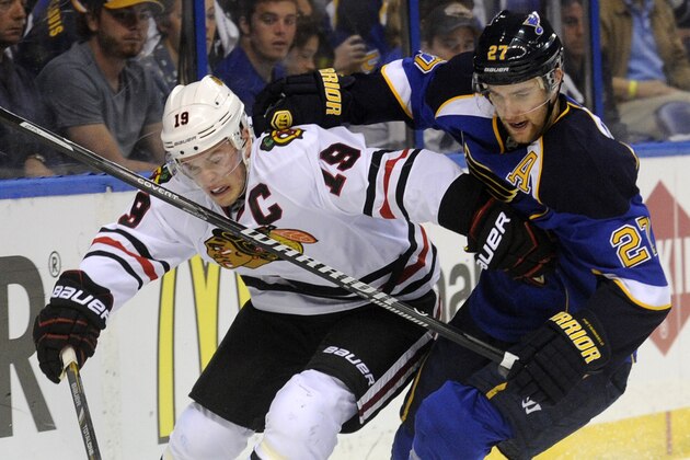 St. Louis Blues' Alex Pietrangelo (27) and Chicago Blackhawks' Jonathan Toews (19) battle for the puck during the first period in Game 2 of a first-round NHL hockey playoff series, Saturday, April 19, 2014, in St. Louis. (AP Photo/Bill Boyce)