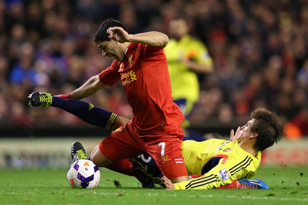 LIVERPOOL, ENGLAND - MARCH 26:  Santiago Vergini of Sunderland  fouls Luis Suarez of Liverpool to concede a free-kick which led to the first goal during the Barclays Premier League match between Liverpool and Sunderland at Anfield on March 26, 2014 in Liverpool, England.  (Photo by Alex Livesey/Getty Images)