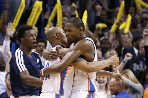 Oklahoma City Thunder forward Kevin Durant (35) embraces teammate Caron Butler, left, after the Thunder defeated the Detroit Pistons in an NBA basketball game in Oklahoma City, Wednesday, April 16, 2014. Oklahoma City won 112-111. (AP Photo/Sue Ogrocki)