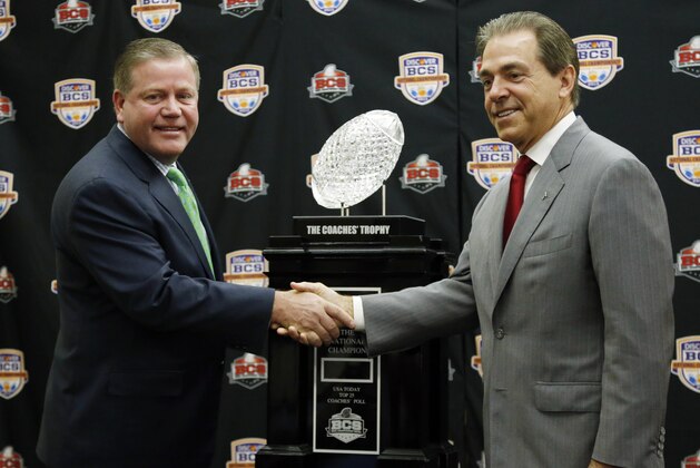 Alabama head coach Nick Saban and Notre Dame head coach Brian Kelly pose with The Coaches' Trophy during a news conference for the BCS National Championship college football game Sunday, Jan. 6, 2013, in Miami. (AP Photo/John Bazemore)
