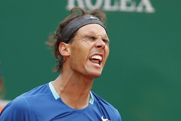 Rafael Nadal of Spain reacts after losing a point against David Ferrer of Spain during their quarterfinals match of the Monte Carlo Tennis Masters tournament in Monaco, Friday, April 18, 2014. Ferrer won 7-6 6-4. (AP Photo/Michel Euler)