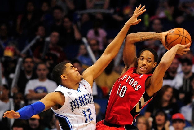 Mar 30, 2014; Orlando, FL, USA; Toronto Raptors guard DeMar DeRozan (10) looks to pass the ball as Orlando Magic forward Tobias Harris (12) defends at Amway Center. The Raptors won 98-93. Mandatory Credit: David Manning-USA TODAY Sports