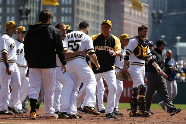 Pittsburgh Pirates' Russell Martin (55) is restrained by teammate Gaby Sanchez, center, as they walk to the dugout with manager Clint Hurdle, right, after a brawl between the Pittsburgh Pirates and the Milwaukee Brewers during the third inning of a baseball game in Pittsburgh Sunday, April 20, 2014. Brewers' Carlos Gomez and Pirates' Travis Snider were ejected from the game. (AP Photo/Gene J. Puskar) Pittsburgh Pirates' Russell Martin (55) is restrained by teammate Gaby Sanchez, center, as they walk to the dugout with manager Clint Hurdle, right, after a brawl between the Pittsburgh Pirates and the Milwaukee Brewers during the third inning of a baseball game in Pittsburgh Sunday, April 20, 2014. Brewers' Carlos Gomez and Pirates' Travis Snider were ejected from the game. (AP Photo/Gene J. Puskar)