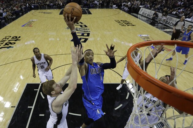 Dallas Mavericks' Monta Ellis (11) drives to the basket between San Antonio Spurs' Matt Bonner, left, and Tim Duncan, right, during the first quarter of Game 1 of the opening-round NBA basketball playoff series, Sunday, April 20, 2014, in San Antonio. (AP Photo/Eric Gay) Dallas Mavericks' Monta Ellis (11) drives to the basket between San Antonio Spurs' Matt Bonner, left, and Tim Duncan, right, during the first quarter of Game 1 of the opening-round NBA basketball playoff series, Sunday, April 20, 2014, in San Antonio. (AP Photo/Eric Gay)
