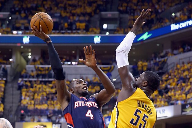 INDIANAPOLIS, IN - APRIL 19:  Paul Milsap #4 of the Atllanta Hawks shoots the ball while defended by Roy Hibbert #55 of the Indiana Pacers in Game 1 of the Eastern Conference Quarterfinals during the 2014 NBA Playoffs at Bankers Life Fieldhouse on April 19, 2014 in Indianapolis, Indiana. NOTE TO USER: User expressly acknowledges and agrees that, by downloading and or using this photograph, User is consenting to the terms and conditions of the Getty Images License Agreement.  (Photo by Andy Lyons/Getty Images)