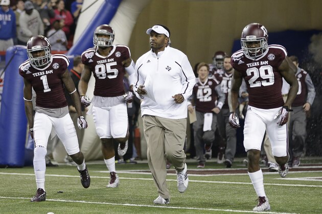 Texas A&M head coach Kevin Sumlin leads his team onto the field in the first half of the Chick-fil-A Bowl NCAA college football game against DukeTuesday, Dec. 31, 2013, in Atlanta. (AP Photo/John Bazemore)