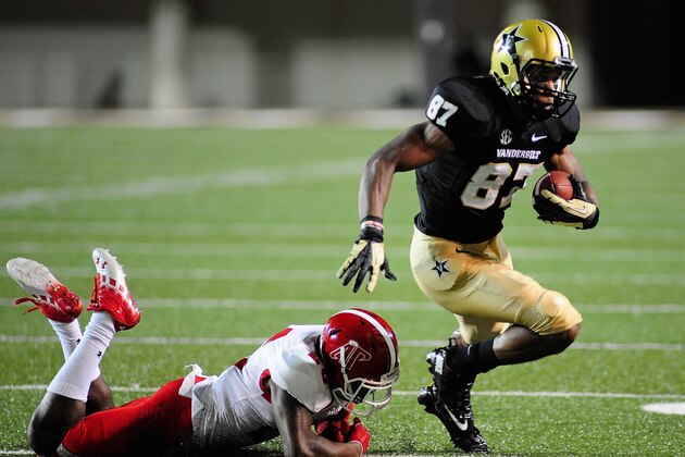 NASHVILLE, TN - SEPTEMBER 07:  Jordan Matthews #87 of the Vanderbilt Commodores breaks a tackle against the Austin Peay Governors at Vanderbilt Stadium on September 7, 2013 in Nashville, Tennessee.  (Photo by Frederick Breedon/Getty Images)