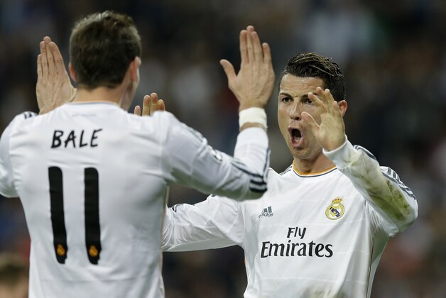 Real's Cristiano Ronaldo, right, celebrates with Real's Gareth Bale after scoring during a Champions League round of 16, second leg, soccer match between Real Madrid and Schalke 04 at the Santiago Bernabeu stadium in Madrid, Tuesday March 18, 2014. (AP Photo/Paul White) Real's Cristiano Ronaldo, right, celebrates with Real's Gareth Bale after scoring during a Champions League round of 16, second leg, soccer match between Real Madrid and Schalke 04 at the Santiago Bernabeu stadium in Madrid, Tuesday March 18, 2014. (AP Photo/Paul White)