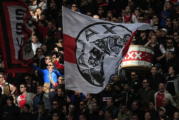 Ajax supporters cheer as they watch the match between Ajax and ADO Den Haag at ArenA stadium in Amsterdam, Netherlands, Sunday, April 13, 2014. Ajax won with a 3-2 score, but did not clinch the Dutch title as nearest opponent Feyenoord also took 3 points with a win against PSV. (AP Photo/Peter Dejong)