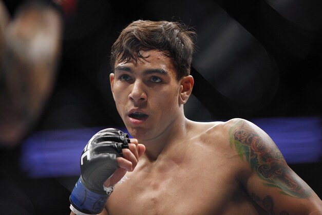 Oct 19, 2013; Houston, TX, USA; Jeremy Larsen (red gloves) fights against Andre Fili (blue gloves) in their catchweight bout during UFC 166 at Toyota Center. Mandatory Credit: Andrew Richardson-USA TODAY Sports