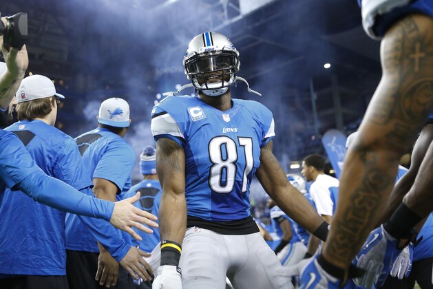 Detroit Lions wide receiver Calvin Johnson (81) is greeted by teammates before the first quarter of an NFL football game against the Baltimore Ravens in Detroit, Monday, Dec. 16, 2013. (AP Photo/Rick Osentoski)