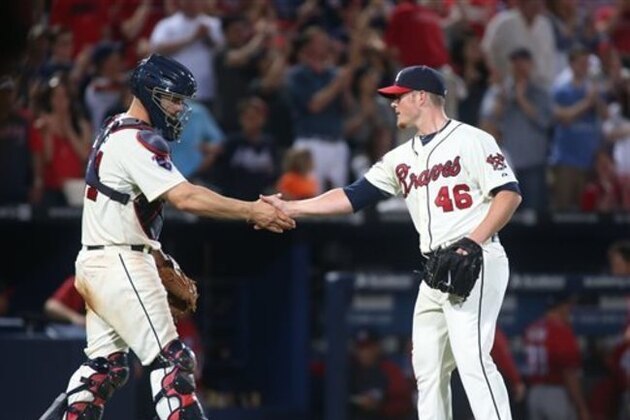 Atlanta Braves closer Craig Kimbrel (46) celebrates with catcher Evan Gattis after a baseball game against the Washington Nationals, Saturday, April 12, 2014, in Atlanta. Atlanta won 6-3. (AP Photo/Jason Getz)