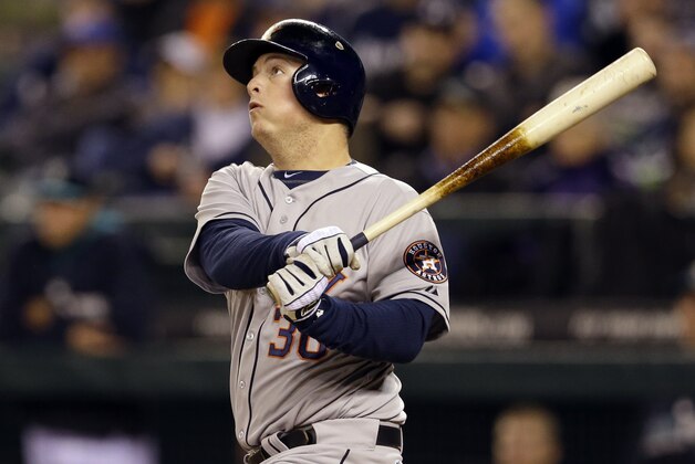 Houston Astros' Matt Dominguez watches his RBI double against the Seattle Mariners Monday, April 21, 2014, during a baseball game in Seattle. (AP Photo/Ted S. Warren)