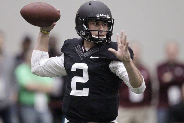 Texas A&M quarterback Johnny Manziel passes the ball during a drill at pro day for NFL football representatives in College Station, Texas, Thursday, March 27, 2014. (AP Photo/Patric Schneider)