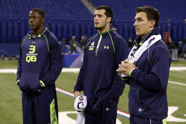Texas A&M quarterback Johnny Manziel, right, Fresno State quarterback Derek Carr, center, and Louisville quarterback Teddy Bridgewater watch drills at the NFL football scouting combine in Indianapolis, Sunday, Feb. 23, 2014. (AP Photo/Michael Conroy)