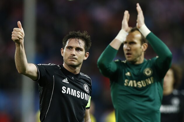 Chelsea's Frank Lampard, left, and Chelsea's Mark Schwarzer greet their fans after the Champions League semifinal first leg soccer match between Atletico Madrid and Chelsea at the Vicente Calderon stadium in Madrid, Spain, Tuesday, April 22, 2014. The match ended in a 0-0 draw. (AP Photo/Andres Kudacki)