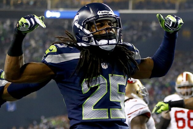 SEATTLE, WA - JANUARY 19:  Cornerback Richard Sherman #25 of the Seattle Seahawks celebrates after he tips the ball leading to an intereption by outside linebacker Malcolm Smith #53 to clinch the victory for the Seahawks against the San Francisco 49ers during the 2014 NFC Championship at CenturyLink Field on January 19, 2014 in Seattle, Washington.  (Photo by Jonathan Ferrey/Getty Images)