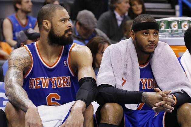 New York Knicks center Tyson Chandler (6) and forward Carmelo Anthony (7) are pictured on the bench late in the fourth quarter of an NBA basketball game against the Oklahoma City Thunder in Oklahoma City, Sunday, Feb. 9, 2014. Oklahoma City won 112-100. (AP Photo/Sue Ogrocki)