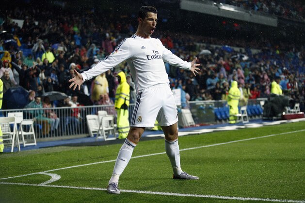 Real's Cristiano Ronaldo celebrates his goal during a Spanish La Liga soccer match between Real Madrid and Rayo Vallecano at the Santiago Bernabeu stadium in Madrid, Spain, Saturday, March 29, 2014. (AP Photo/Andres Kudacki)