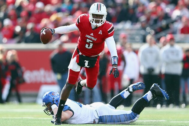 LOUISVILLE, KY - NOVEMBER 23:  Teddy Bridgewater #5 of the Louisville Cardinals avoids the tackle of Chase Rome #47 of the Memphis Tigers at Papa John's Cardinal Stadium on November 23, 2013 in Louisville, Kentucky.  (Photo by Andy Lyons/Getty Images)