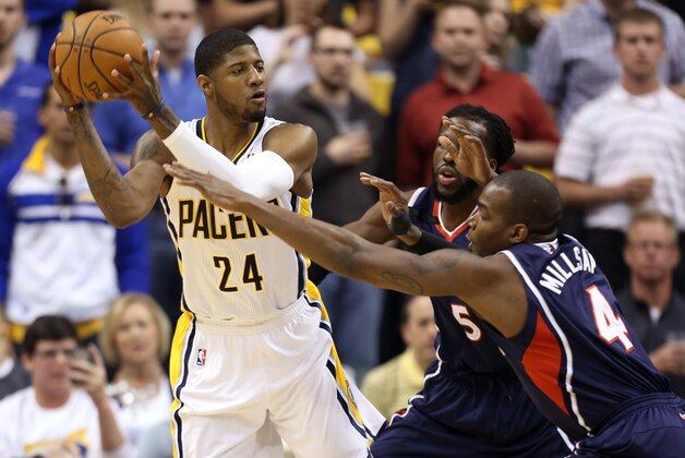 Apr 22, 2014; Indianapolis, IN, USA; Indiana Pacers forward Paul George (24) is guarded by Atlanta Hawks forwards DeMarre Carroll (5) and Paul Millsap (4) in game two during the first round of the 2014 NBA Playoffs at Bankers Life Fieldhouse. Mandatory Credit: Brian Spurlock-USA TODAY Sports