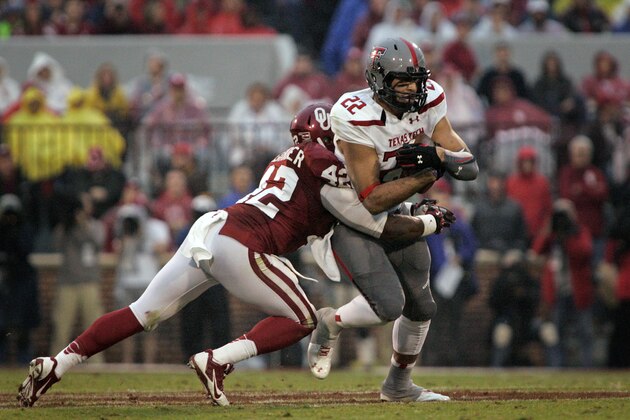 NORMAN, OK - OCTOBER 26:   Linebacker Dominique Alexander #42 of the Oklahoma Sooners tries to take down tight end Jace Amaro #22 of the Texas Tech Red Raiders October 26, 2013 at Gaylord Family-Oklahoma Memorial Stadium in Norman, Oklahoma. Oklahoma defeated Texas Tech 38-30. (Photo by Brett Deering/Getty Images)