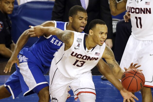 Connecticut guard Shabazz Napier (13) tries to control the ball as Kentucky guard Aaron Harrison (2) defends during the second half of the NCAA Final Four tournament college basketball championship game Monday, April 7, 2014, in Arlington, Texas. (AP Photo/Tony Gutierrez)