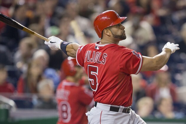Los Angeles Angels Albert Pujols watches the ball after connecting for a two-run homer against Washington Nationals Taylor Jordan in the fifth inning of a baseball game in Washington, Tuesday, April 22, 2014. This was Pujols 500th career home run. (AP Photo/Pablo Martinez Monsivais)