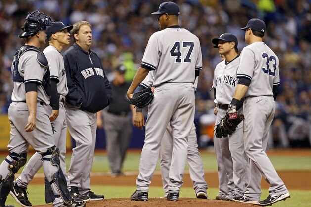 New York Yankees starting pitcher Ivan Nova is visited on the mound by infielders and manager Joe Girardi during the fifth inning of a baseball game against the Tampa Bay Rays Saturday, April 19, 2014, in St. Petersburg, Fla. (AP Photo/Mike Carlson)