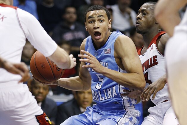 Louisville's Chris Jones (3) pressures North Carolina's Marcus Paige (5) during the first half of an NCAA college basketball game in the Basketball Hall of Fame Tip-Off tournament championship in Uncasville, Conn., Sunday, Nov. 24, 2013. (AP Photo/Michael Dwyer)