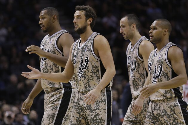 San Antonio Spurs players, from left to right, Boris Diaw, of France; Marco Belinelli, of Italy; Manu Ginobili, of Argentina, and Patty Mills, of Australia, walk off the court during a timeout in the second half of an NBA basketball game against the Washington Wizards, Wednesday, Nov. 13, 2013, in San Antonio. San Antonio won 92-79. The Spurs wore military-inspired camouflage uniforms to honor the servicemen and women of the Armed Forces. (AP Photo/Eric Gay) San Antonio Spurs players, from left to right, Boris Diaw, of France; Marco Belinelli, of Italy; Manu Ginobili, of Argentina, and Patty Mills, of Australia, walk off the court during a timeout in the second half of an NBA basketball game against the Washington Wizards, Wednesday, Nov. 13, 2013, in San Antonio. San Antonio won 92-79. The Spurs wore military-inspired camouflage uniforms to honor the servicemen and women of the Armed Forces. (AP Photo/Eric Gay)