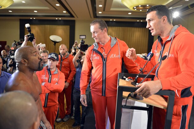 Former heavyweight world champion Shannon Briggs of the United States, left, shows up at a press conference of boxer Wladimir Klitschko of Ukraine, right,  during a press conference ahead of Klitschko's  IBF, IBO, WBO and WBA heavyweight title bout against  challenger Alex Leapai from Australia-Samoa in Duesseldorf, Germany, April 22, 2014. Briggs demanded a title fight against Klitschko in the US. (AP Photo/Martin Meissner)